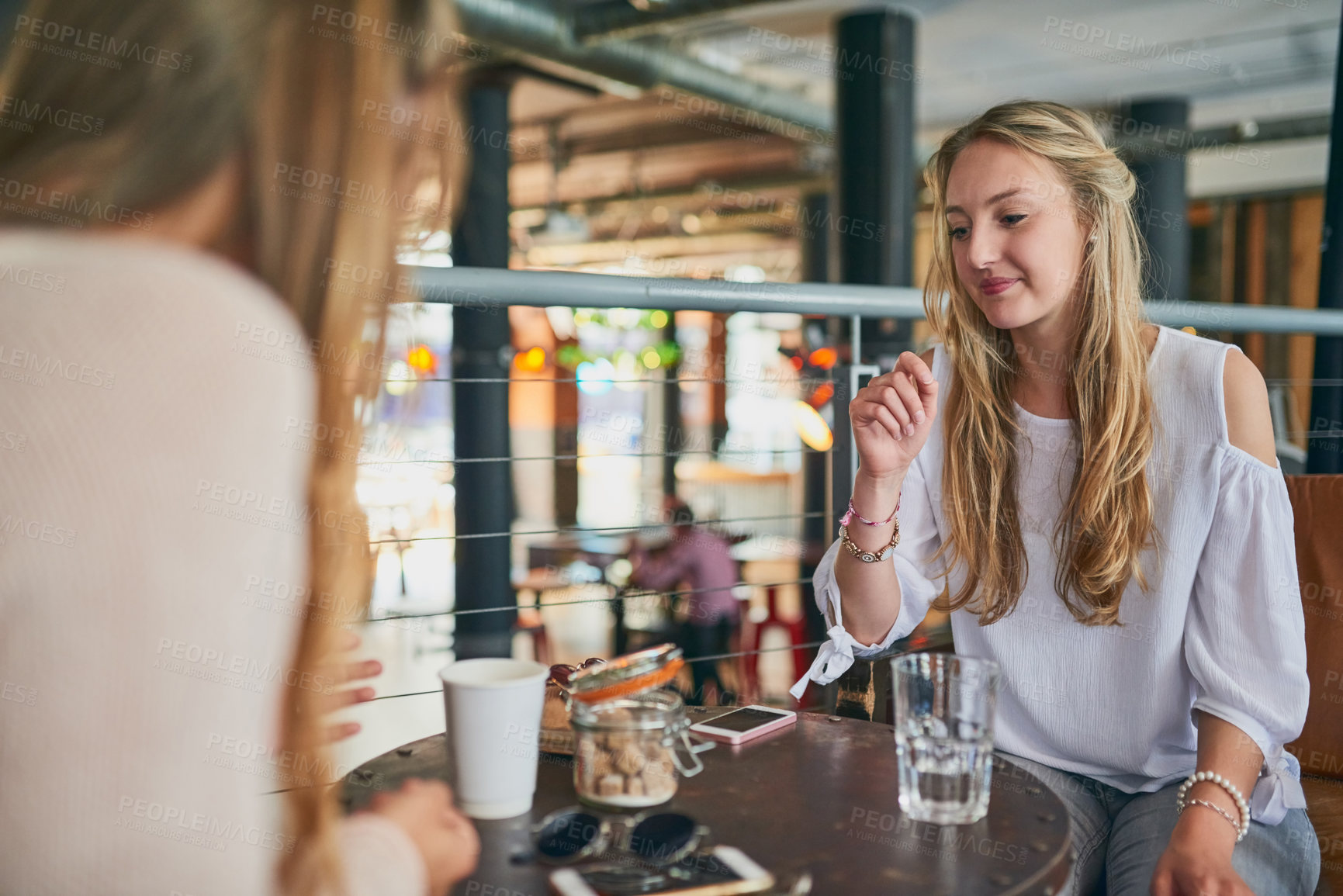 Buy stock photo Friends, relax and talking in coffee shop for social, reunion and bonding together with water by table. Women, communication and support in cafe for conversation, lunch break or girls date on weekend