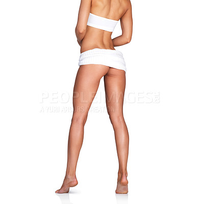 Buy stock photo Studio shot of an unrecognizable young woman covered with a white sheet against a white background