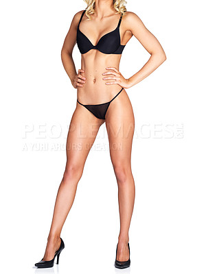 Buy stock photo Studio shot of an unrecognizable young woman in high heels and lingerie posing against a white background