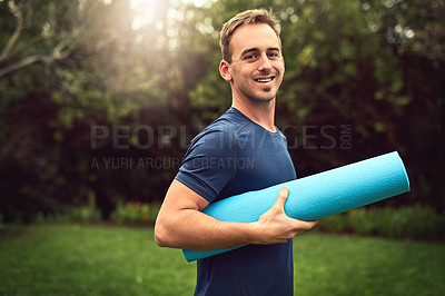 Buy stock photo Portrait of a young man holding a yoga mat outdoors