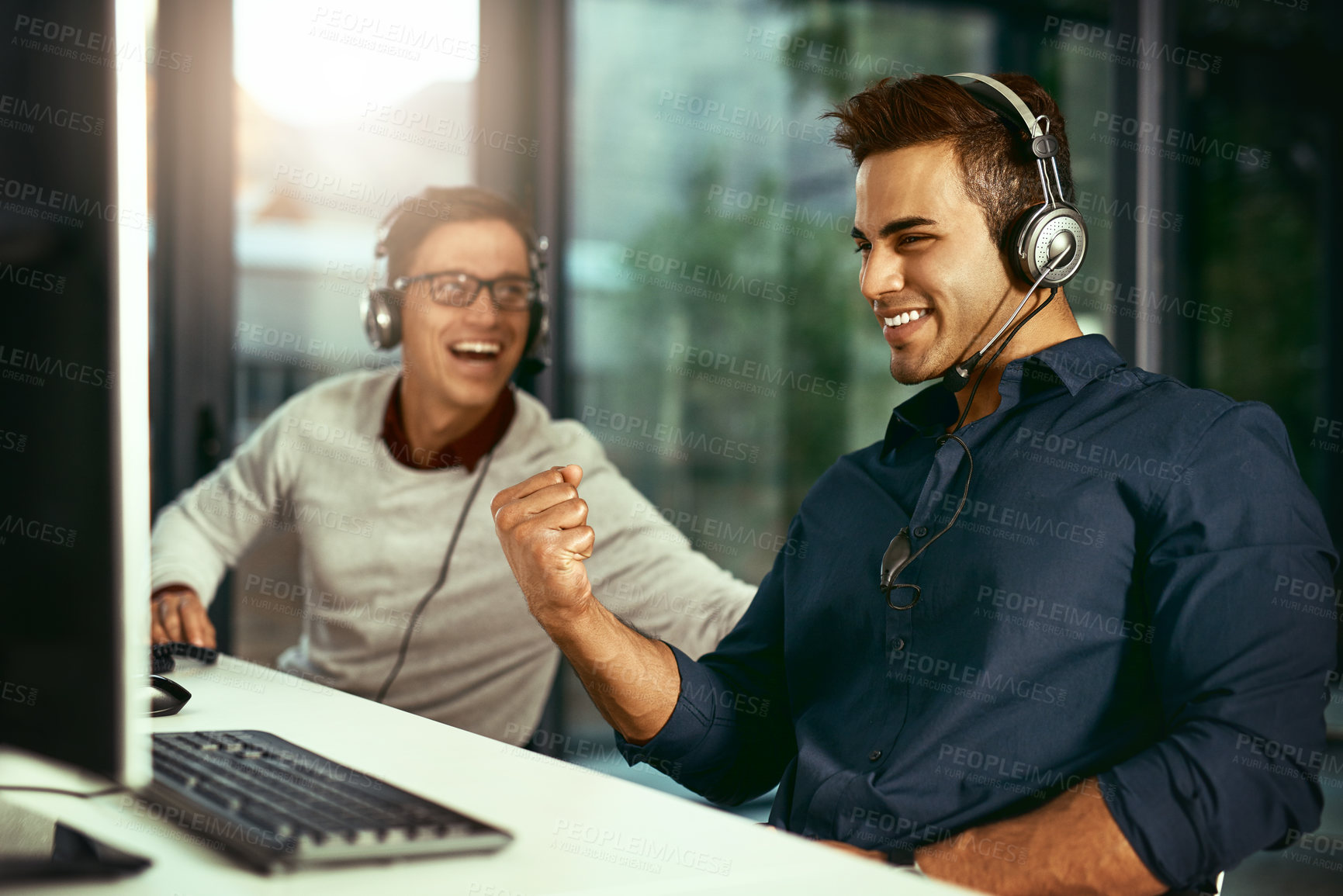 Buy stock photo Man, fist pump and tech in call center for success, telemarketing or good job with colleague. Agent, headset or excited in office for winner, celebration or digital sales in investment for commission