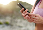 Using her phone's GPS to plan her hiking route