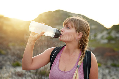 Buy stock photo Woman, hiking break and outdoor for drinking water, travel vacation and mountain for exercise in nature. Female person, thinking and liquid hydration on adventure, mineral nutrition and trekking