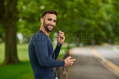 Buy stock photo Happy, nature and portrait of man with earphones for listening to music, podcast or radio. Fitness, workout and male athlete with audio tech for streaming running playlist on phone at outdoor park.