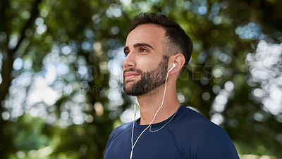 Buy stock photo Thinking, fitness and man in nature with earphones for listening to music, podcast or radio. Sports, workout and male athlete with audio tech for streaming cardio playlist for running at outdoor park