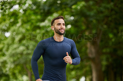 Buy stock photo Running, fitness and man in nature with earphones for listening to music, podcast or radio. Sports, workout and male athlete with audio tech for streaming cardio playlist for exercise at outdoor park