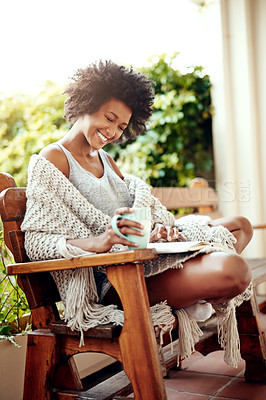 Buy stock photo Black woman, reading and backyard patio with book and coffee feeling relax and happy. Happiness, African female person and smile in a home garden in the morning with tea outdoor in the sun with story