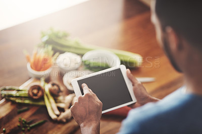 Buy stock photo Closeup of hands of man holding a tablet to search a recipe, do research or look for ingredients while cooking dinner, lunch or breakfast. Scrolling online, browsing app and searching for meal ideas