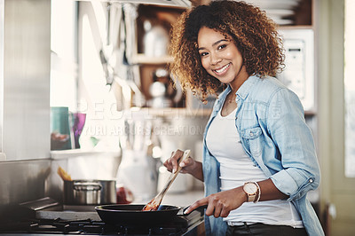 Buy stock photo Portrait of a happy young woman preparing a meal on the stove at home