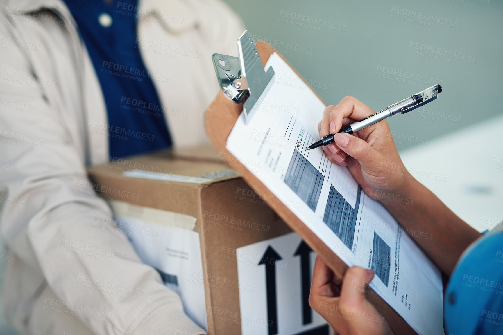 Buy stock photo Closeup shot of a woman signing for a delivery from the courier