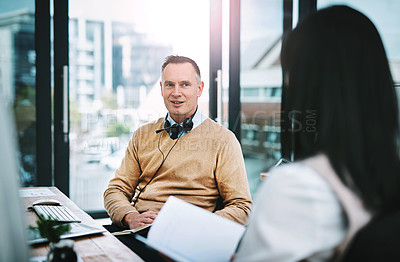 Buy stock photo Cropped shot of two call center agents talking in their office