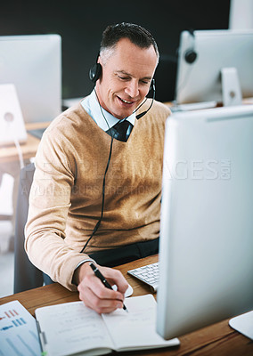 Buy stock photo Cropped shot of a handsome mature male operator working at his desk