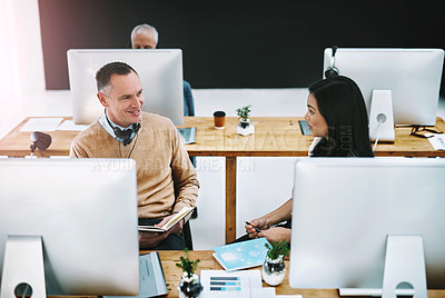 Buy stock photo Cropped shot of two call center agents talking in their office