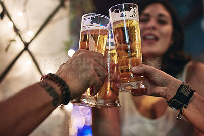 Buy stock photo Cropped shot of three friends having beers in a bar