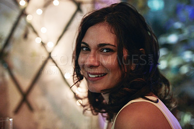 Buy stock photo Cropped portrait of an attractive young woman sitting in a club