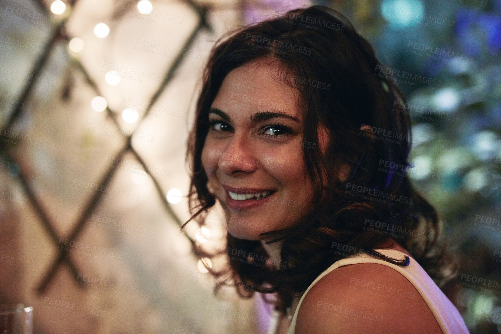 Buy stock photo Cropped portrait of an attractive young woman sitting in a club