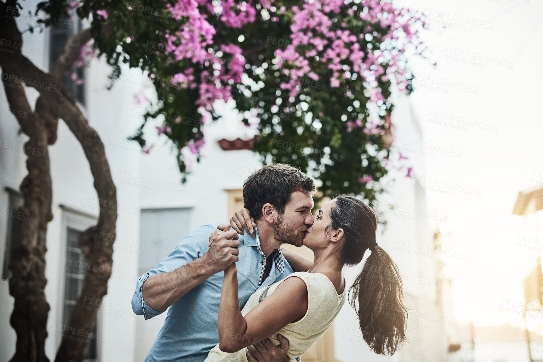 Buy stock photo Couple, kiss and dancing in city on holiday, marriage commitment and travel to Greece. People, outdoor date and support for security in relationship, romance and together on honeymoon weekend trip