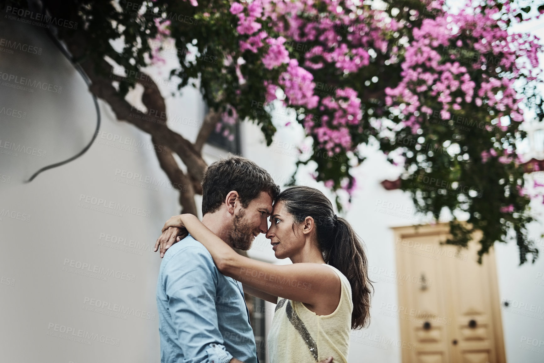 Buy stock photo Couple, forehead and romance in city on holiday, marriage commitment and travel to Greece. People, outdoor hug and support for security in relationship, bonding and together on honeymoon weekend