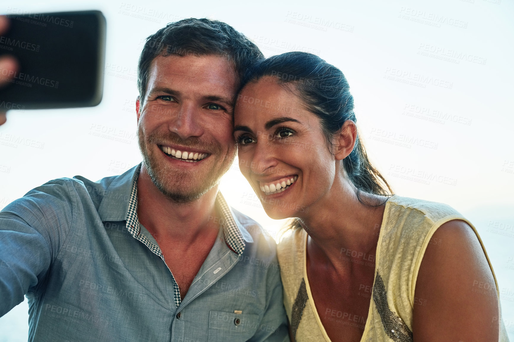 Buy stock photo Outdoor, couple and happy with selfie on date for social media post and profile picture in Spain. People, relationship and smile or satisfied with memories for bonding, support and care on break