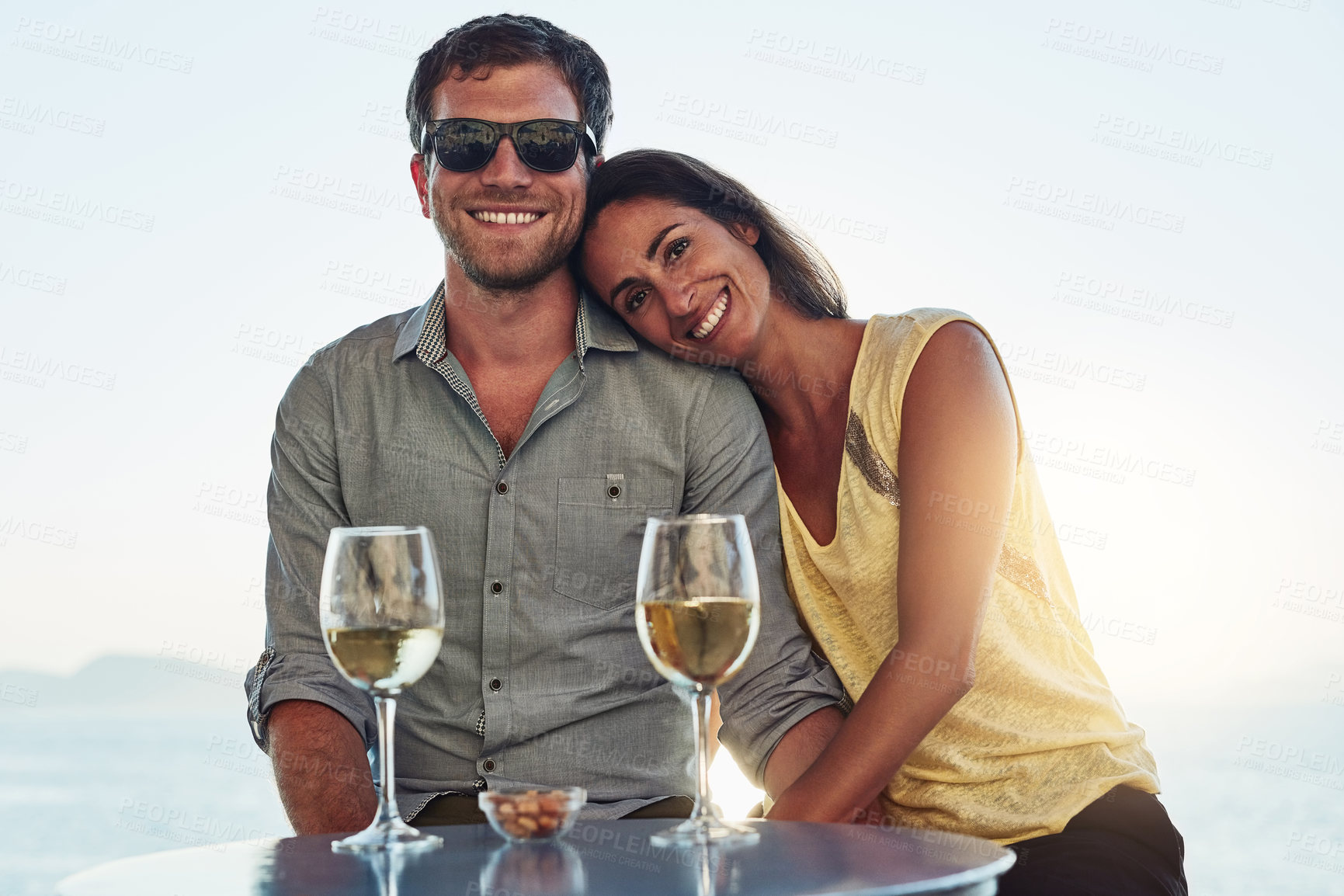 Buy stock photo Outdoor, couple and smile with wine glass on portrait for romantic date, bonding and love in Spain. People, relationship and happy outside with alcohol on break or holiday for rest and support