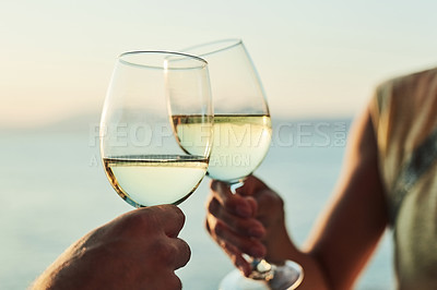 Buy stock photo Cropped shot of a couple making a toast while out on a date