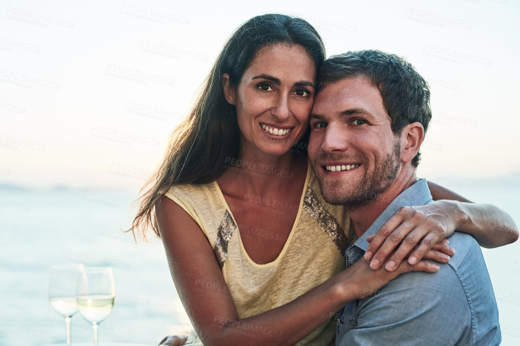 Buy stock photo Outdoor, couple and hug with wine glass on portrait for romantic date, bonding and love in Spain. People, relationship and happiness outside with alcohol on break or holiday for rest and support