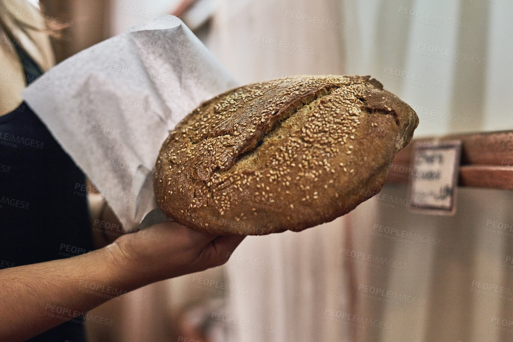 Buy stock photo Person, fresh bread and package in bakery for takeaway, customer order and sale in service industry. Baker, sourdough and paper bag at shelf for choice, option or artisanal loaf in cafe or restaurant