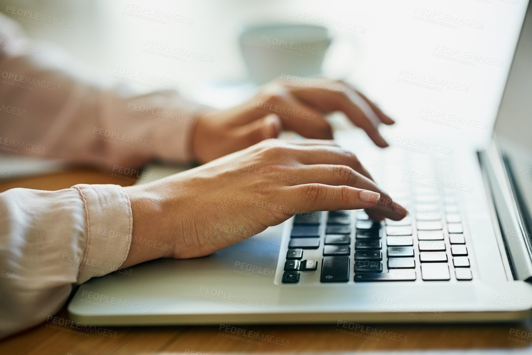 Buy stock photo Closeup shot of an unidentifiable businesswoman using a laptop in an office