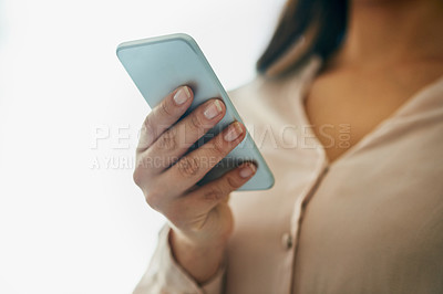 Buy stock photo Closeup shot of an unidentifiable businesswoman using a cellphone in an office