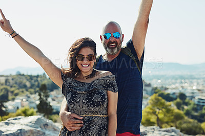 Buy stock photo Outdoor, couple and happy with open arms on hill in portrait for fun, bonding and holiday in Spain. People, relationship and smile with sunglasses for summer vacation, travel and break for freedom