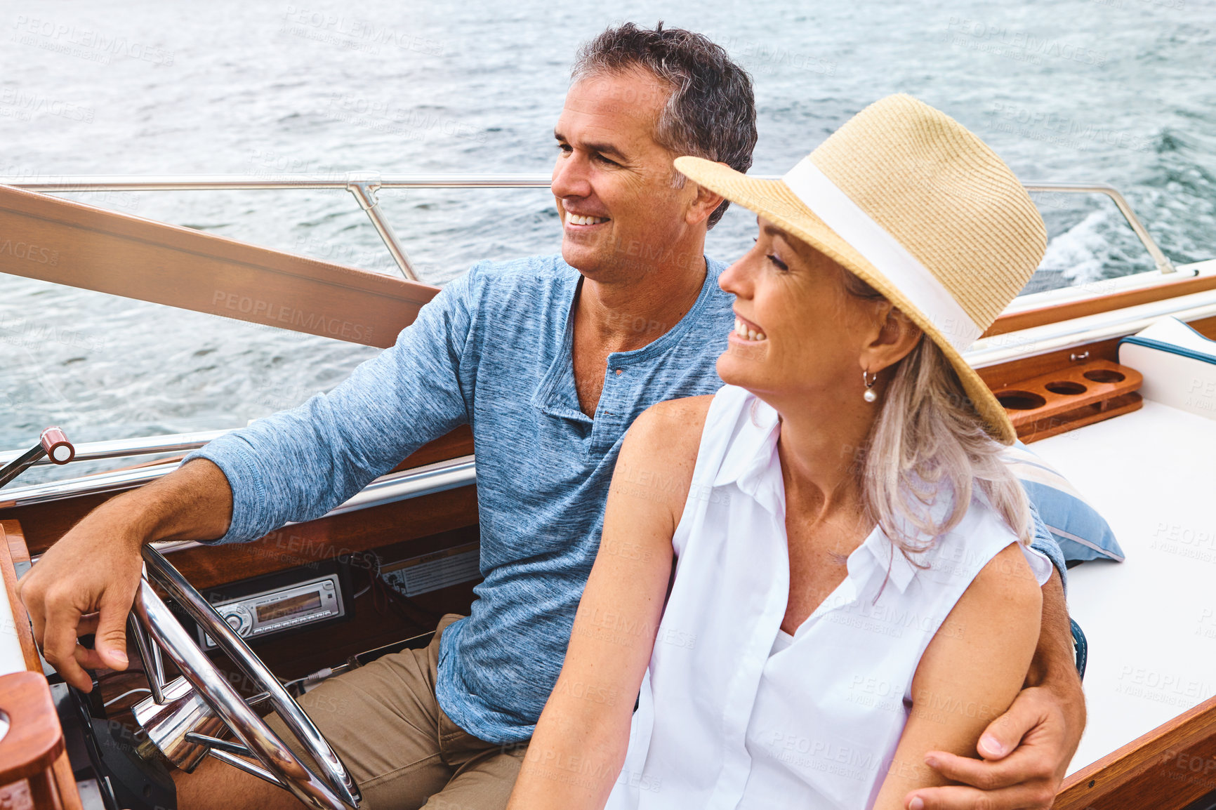 Buy stock photo Happy couple, lake adventure and travel in boat on holiday, relax on cruise date for retirement together. Mature, woman and man driving on water yacht for vacation with happiness, summer in Bali