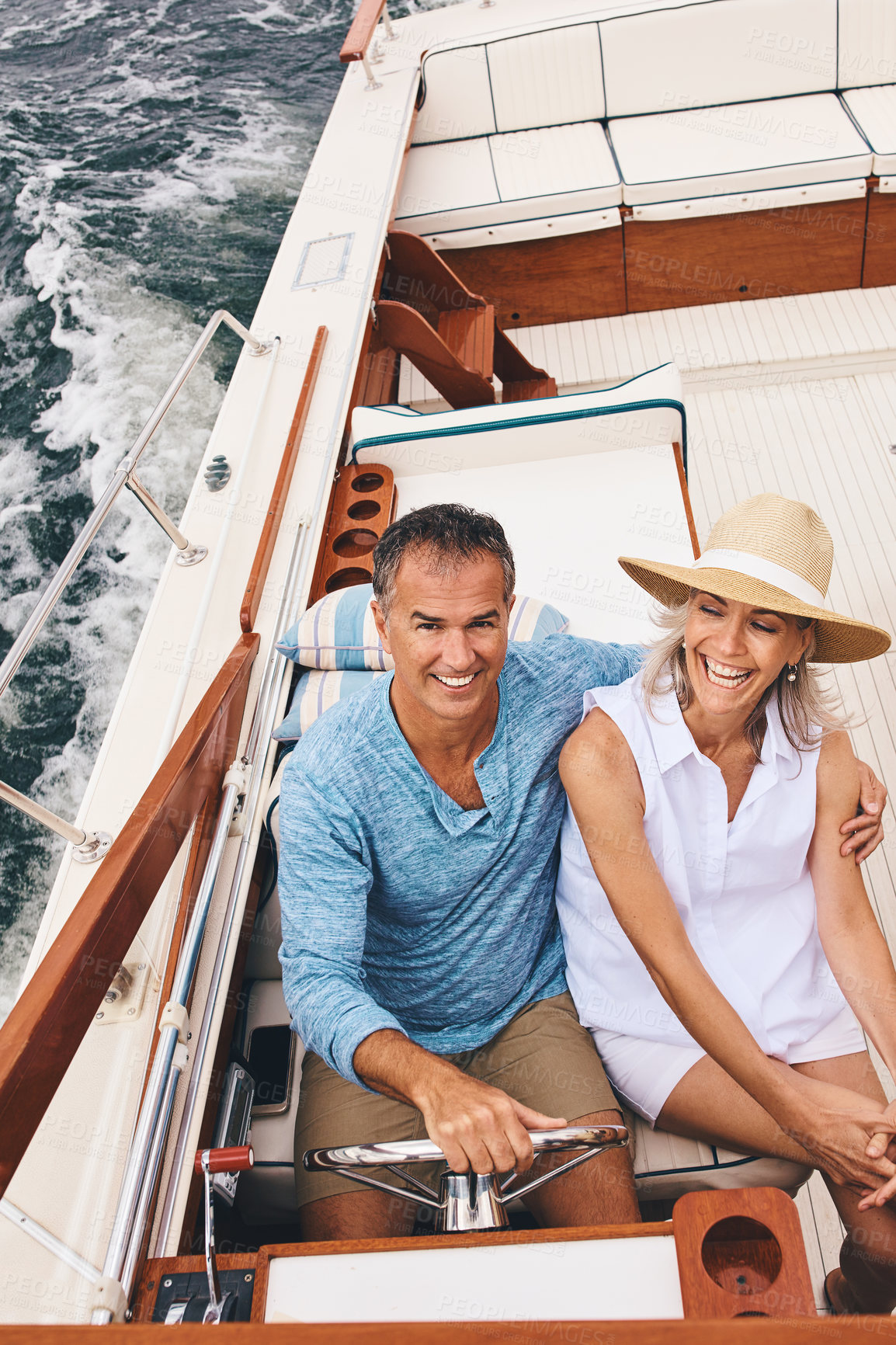 Buy stock photo Boat, date and laughing with mature couple on ocean or sea from above for travel and vacation. Holiday, love or romance with man and woman riding in yacht together for adventure, journey or trip