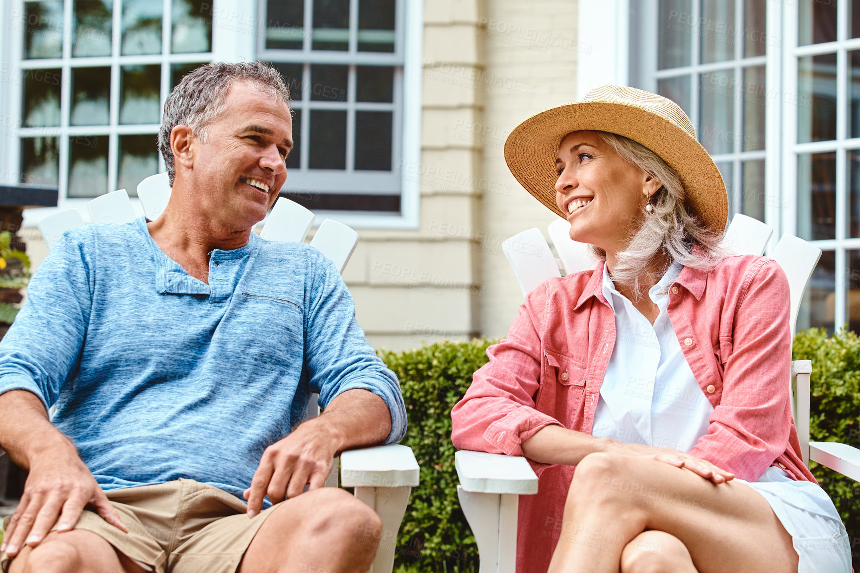 Buy stock photo Mature couple, garden and relax on chair with conversation, bonding and connection in summer at house. Man, woman and happy with discussion for memory, talking and love on grass in home backyard