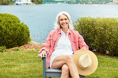 Buy stock photo Lake, portrait and relax with senior woman outdoor in garden for holiday, retirement or vacation. Chair, nature and smile with happy elderly person sitting by water in park for chilling or wellness