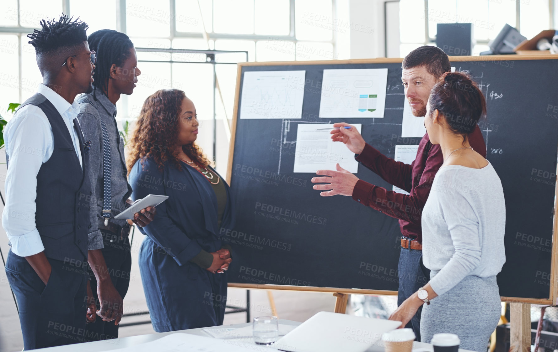 Buy stock photo Shot of a group of businesspeople brainstorming in an office