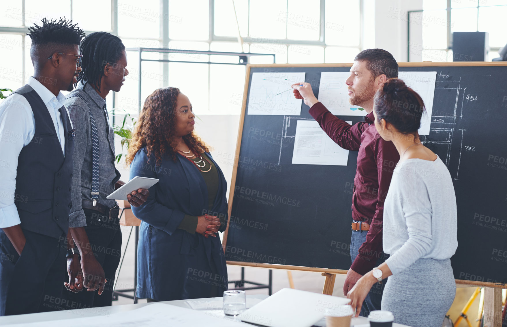 Buy stock photo Shot of a group of businesspeople brainstorming in an office