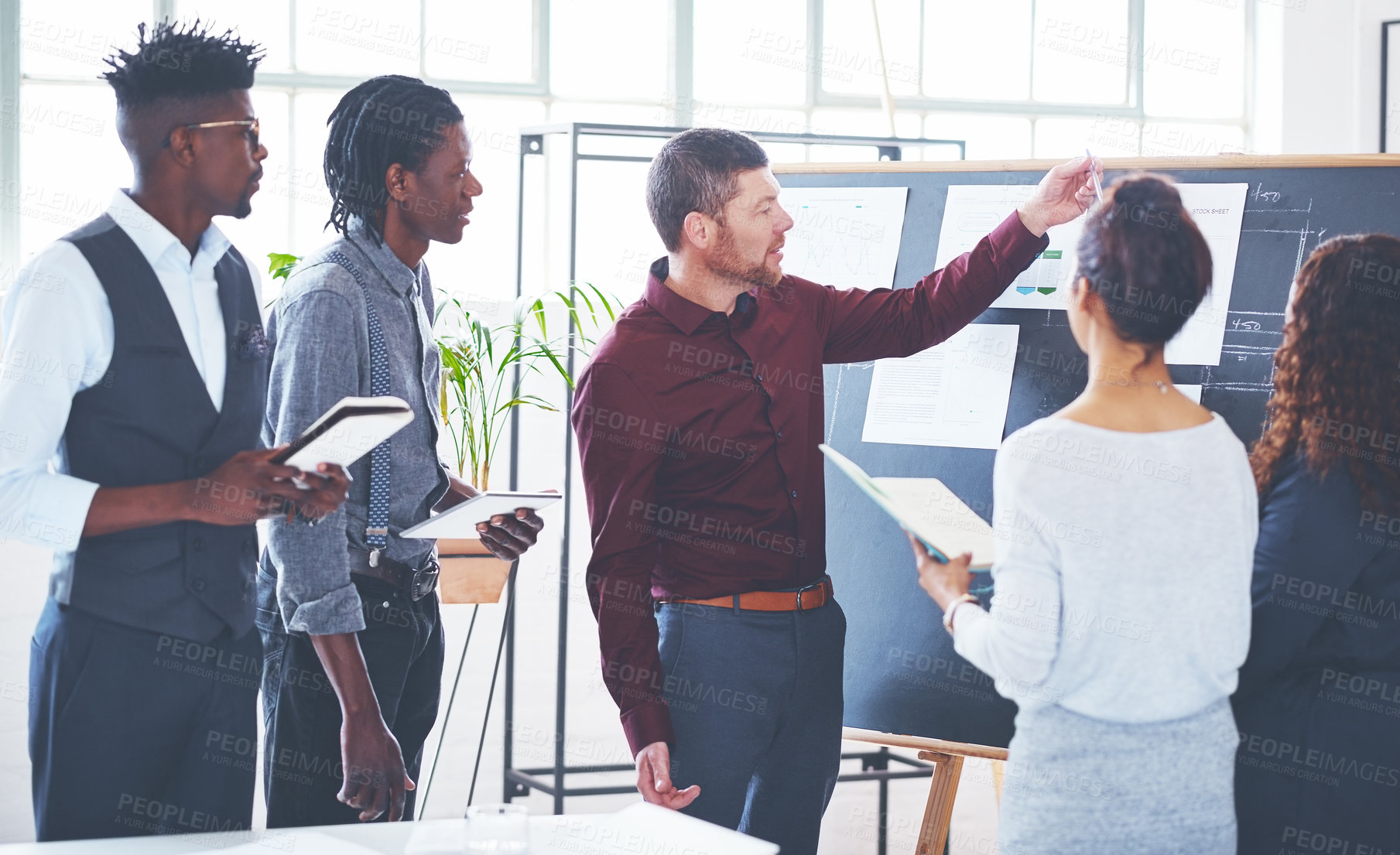 Buy stock photo Shot of a group of businesspeople brainstorming in an office