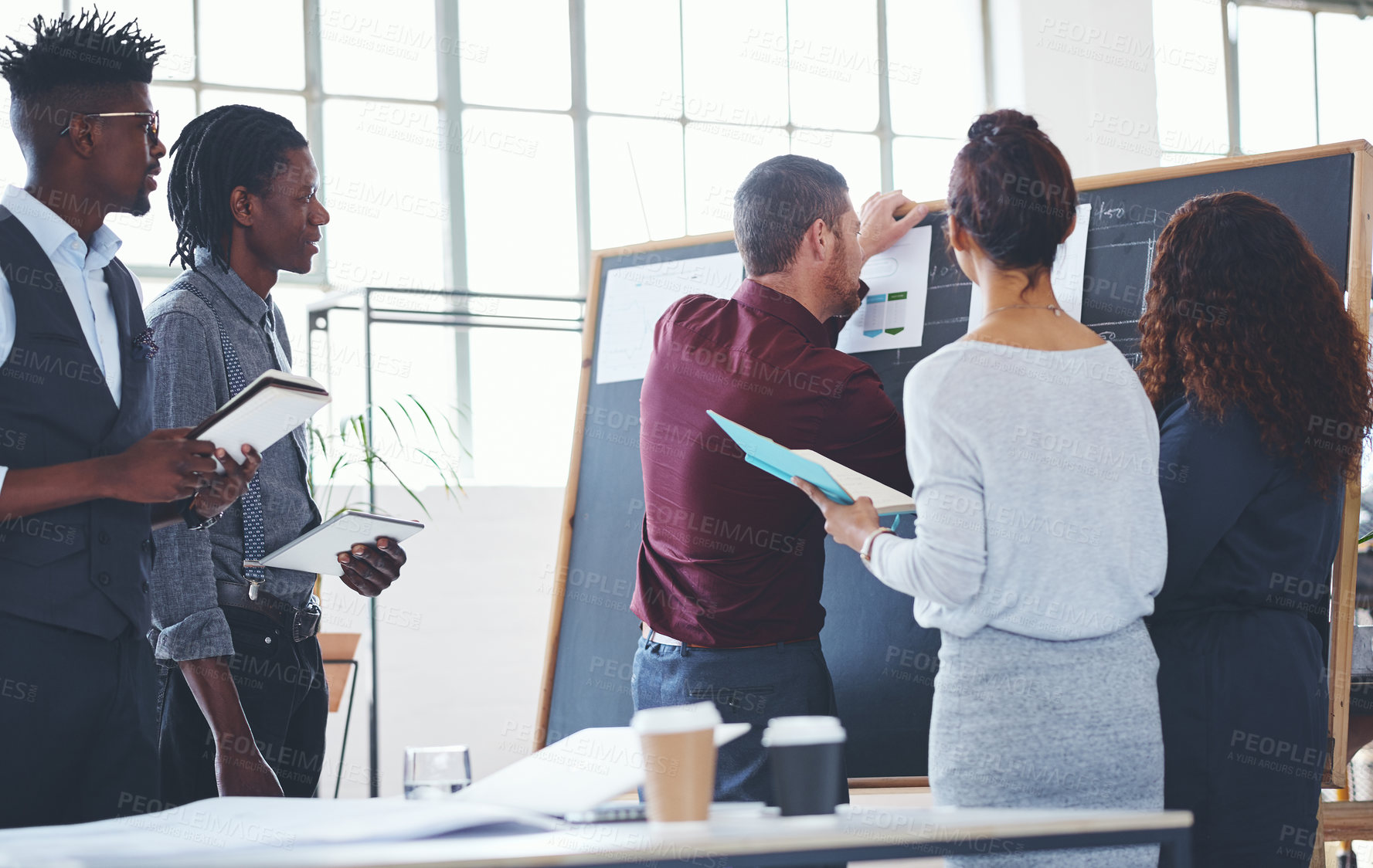 Buy stock photo Shot of a group of businesspeople brainstorming in an office