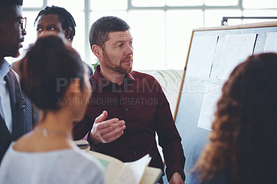 Buy stock photo Shot of a group of businesspeople brainstorming in an office