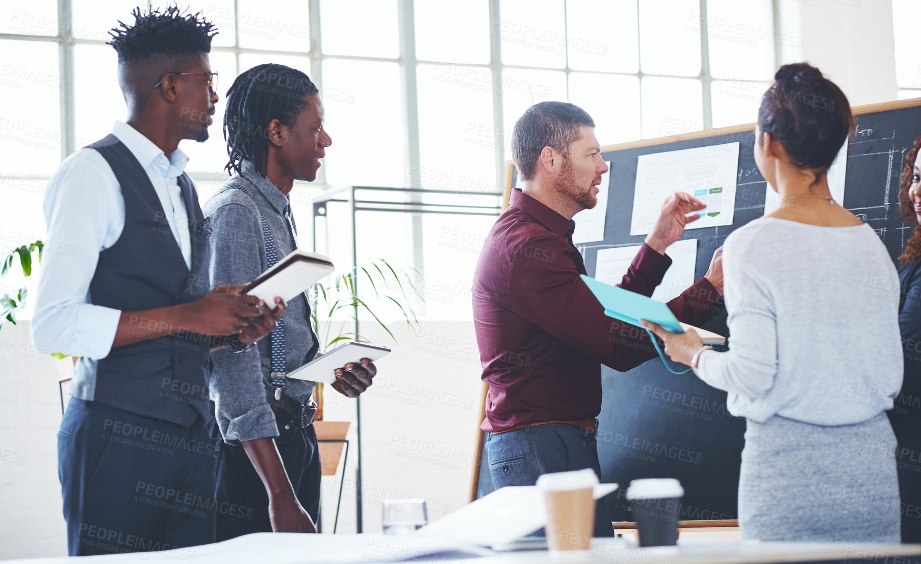 Buy stock photo Shot of a group of businesspeople brainstorming in an office