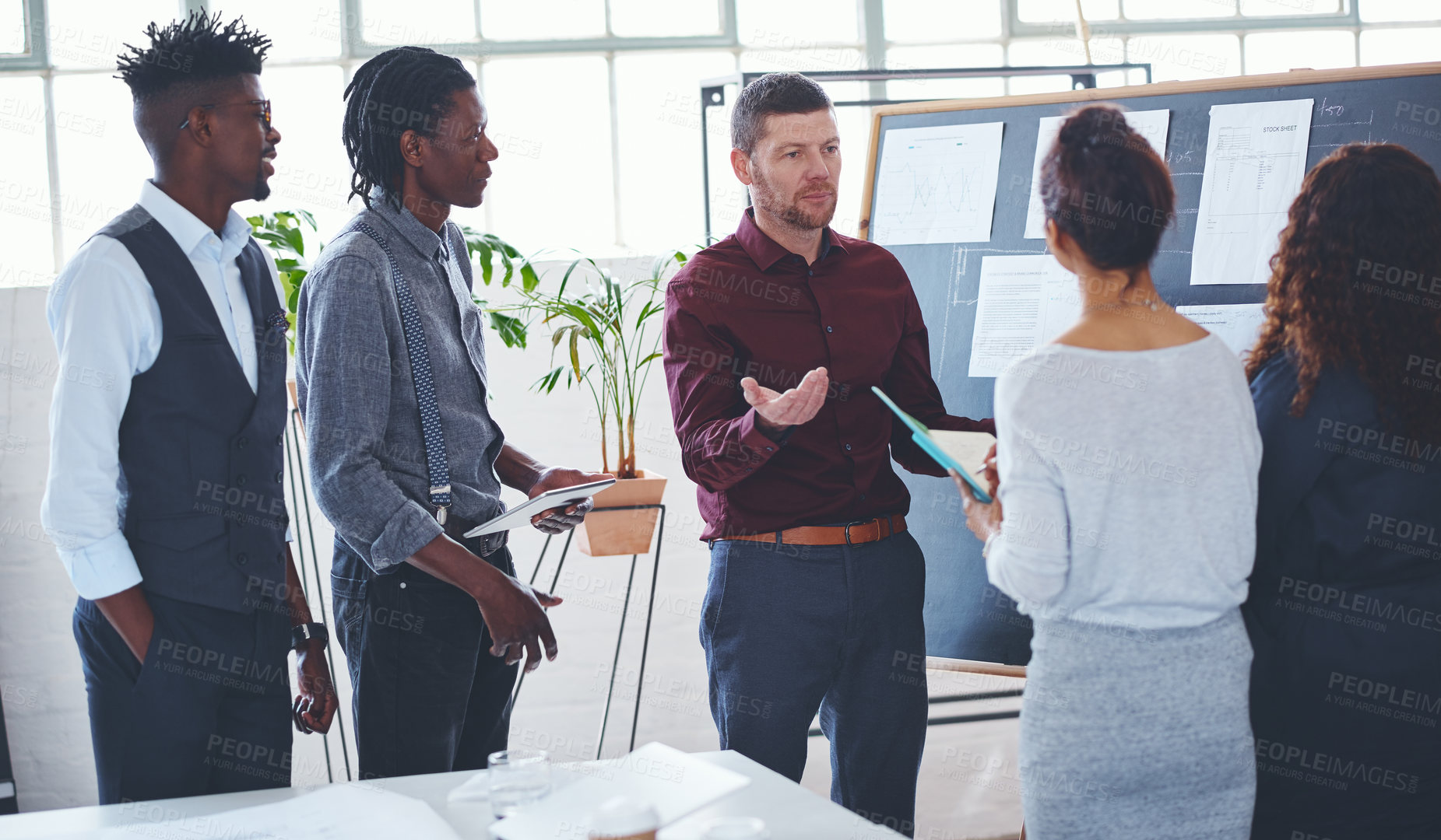 Buy stock photo Shot of a group of businesspeople brainstorming in an office