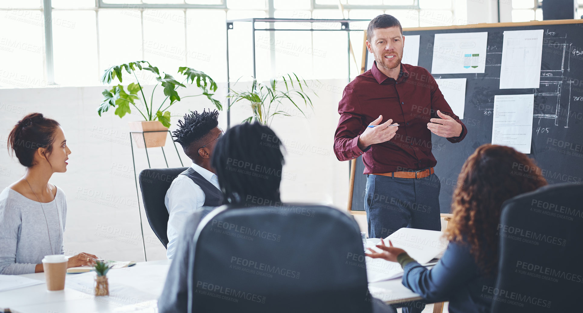 Buy stock photo Shot of a businessman giving a presentation to his colleagues in an office