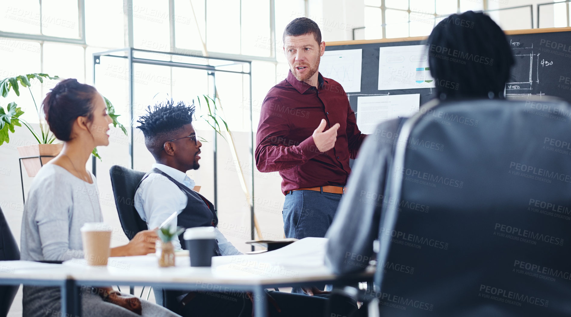 Buy stock photo Shot of a businessman giving a presentation to his colleagues in an office