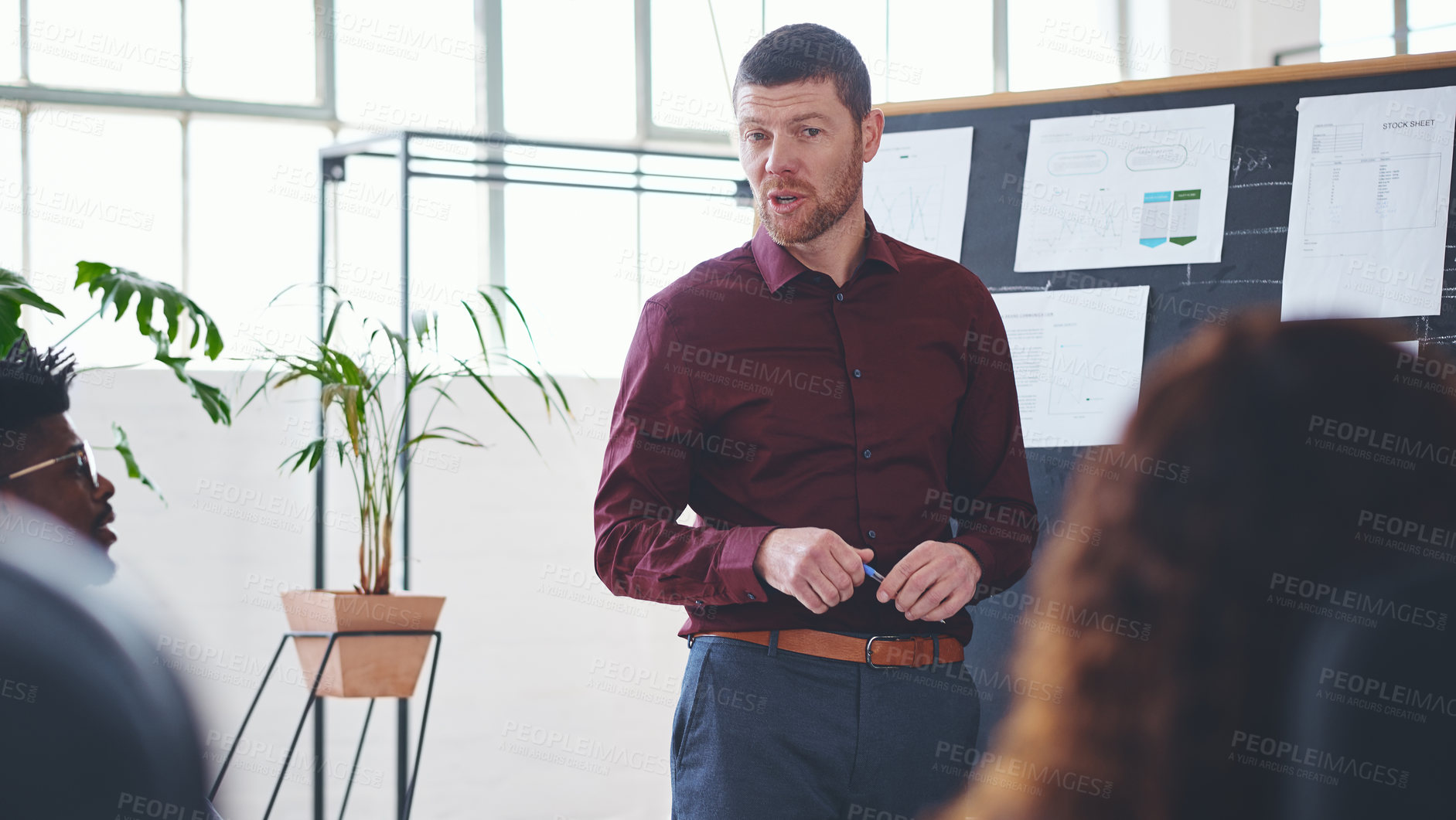 Buy stock photo Shot of a businessman giving a presentation to his colleagues in an office