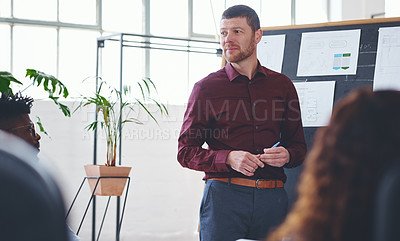 Buy stock photo Shot of a businessman giving a presentation to his colleagues in an office