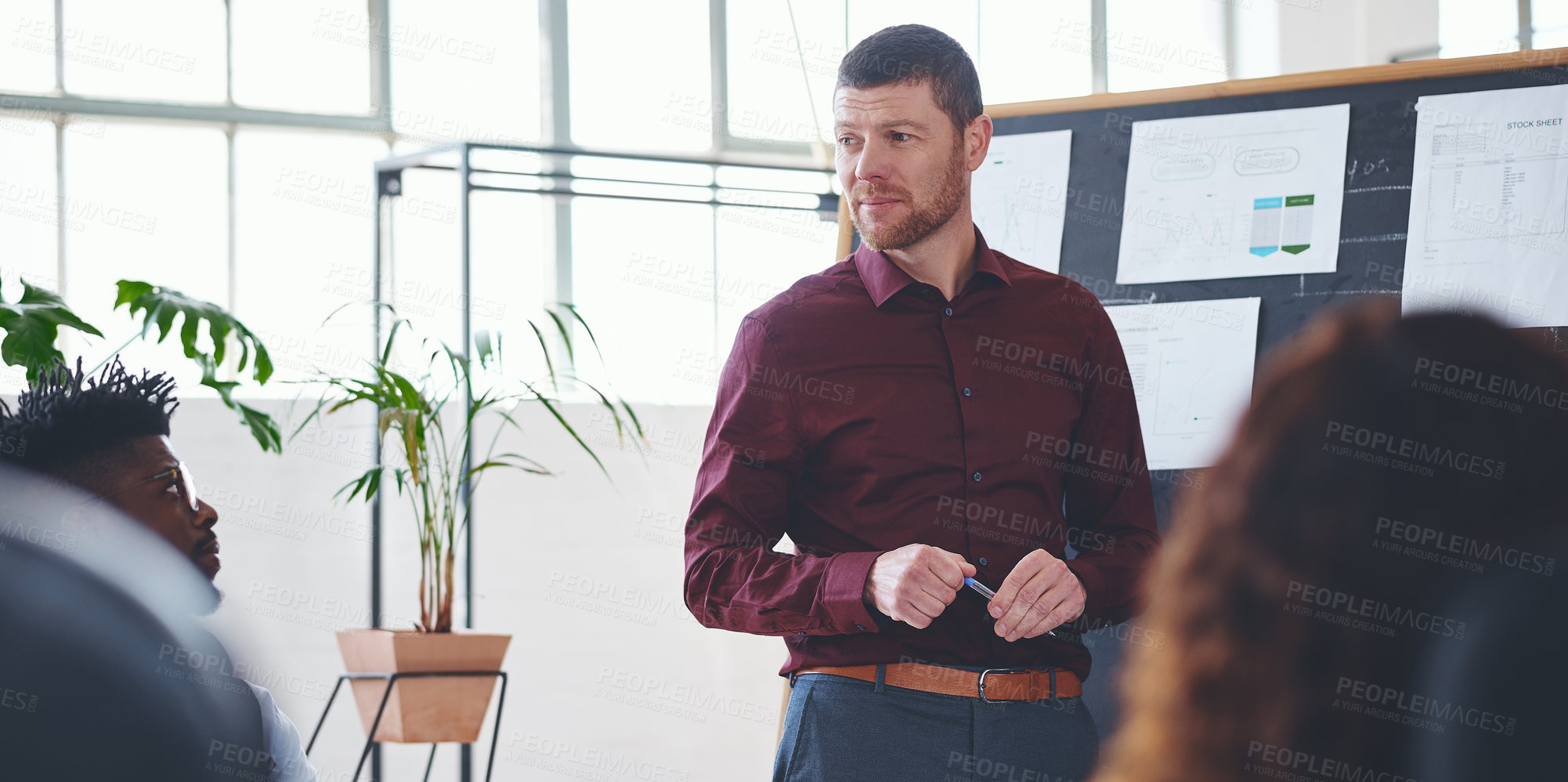 Buy stock photo Shot of a businessman giving a presentation to his colleagues in an office