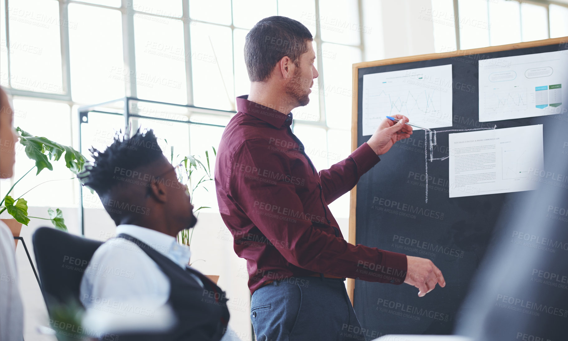 Buy stock photo Shot of a businessman giving a presentation to his colleagues in an office