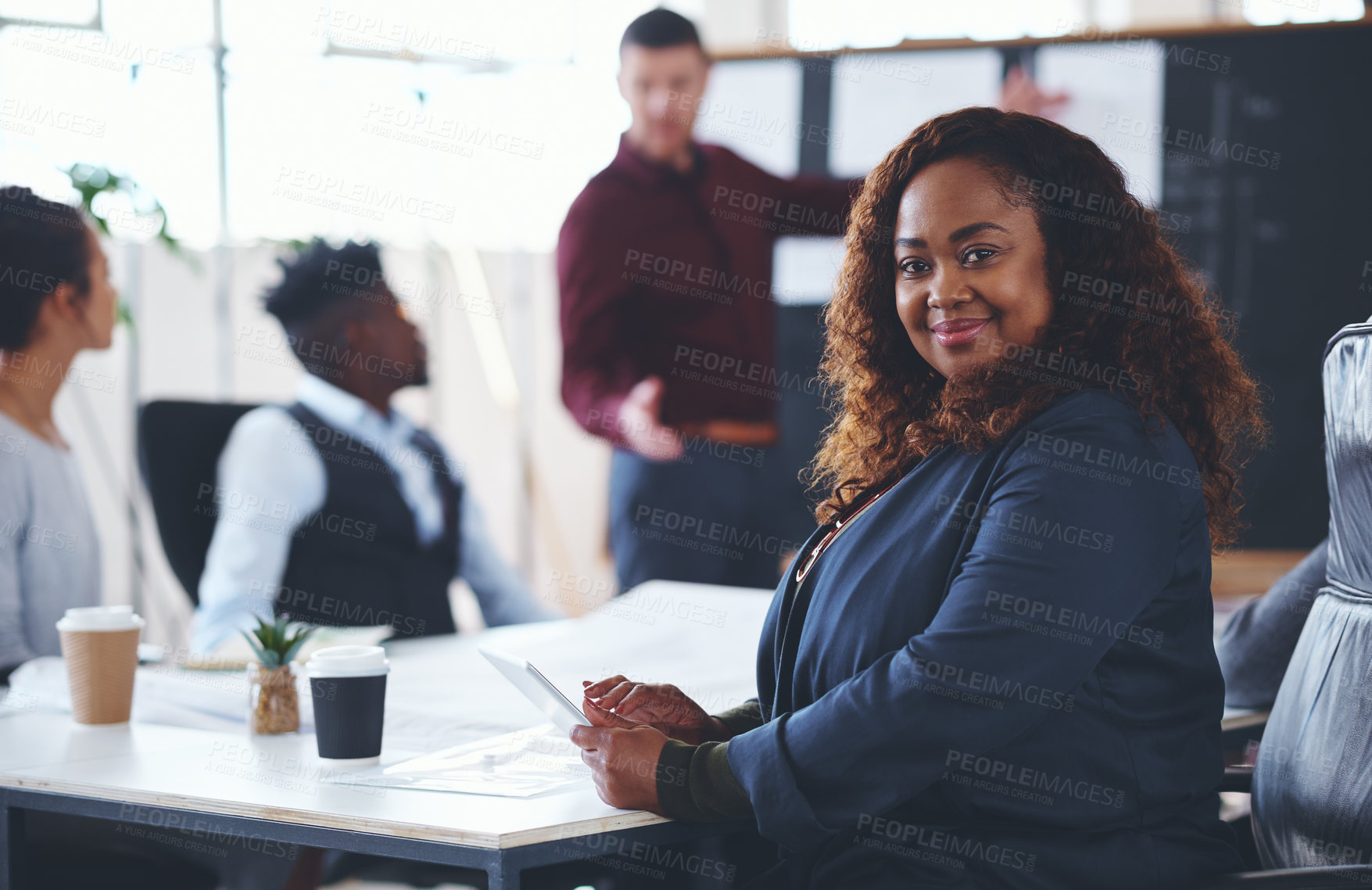 Buy stock photo Portrait of a young businesswoman using a digital tablet during a meeting in an office