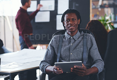 Buy stock photo Portrait of a young businessman using a digital tablet during a meeting in an office