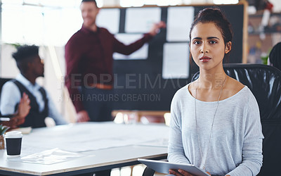 Buy stock photo Portrait of a young businesswoman using a digital tablet during a meeting in an office